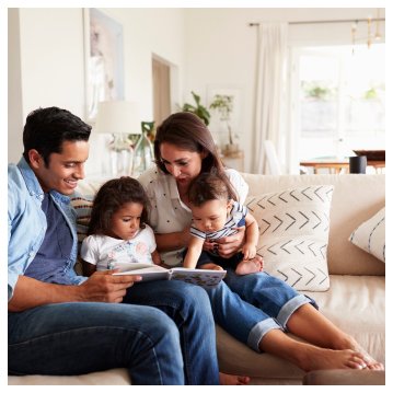 a family sitting on a sofa in their clean home