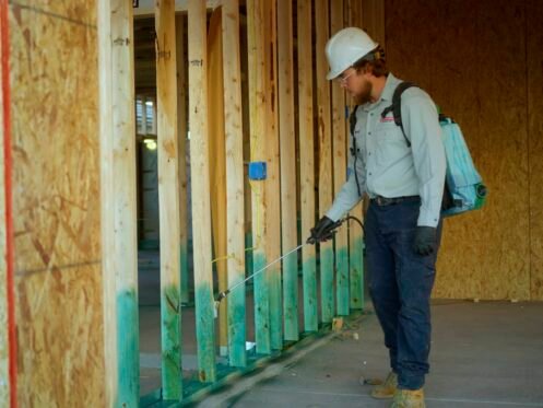 Man sprays wall frame