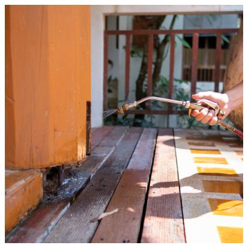 person spraying wood for termites